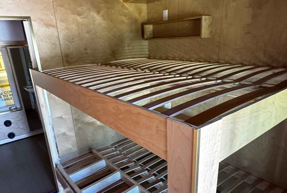 bed frame inside sleeper pod for employee