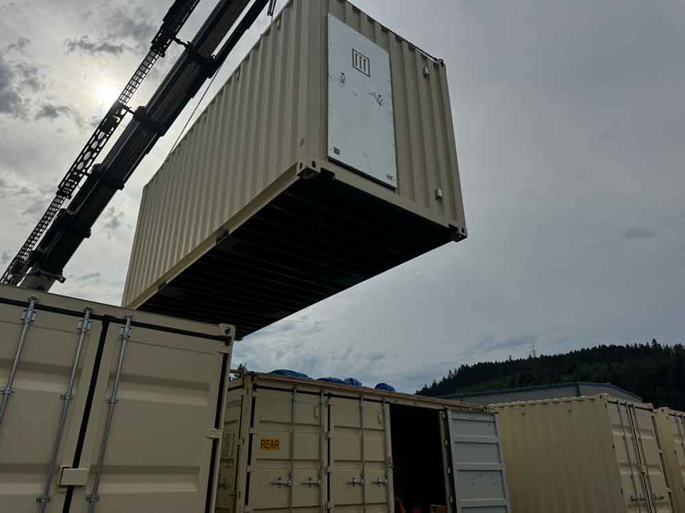 pod being hoisted by a crane